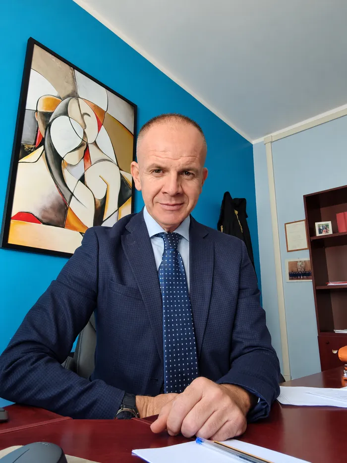 L'avvocato nel suo ufficio, davanti a un dipinto astratto